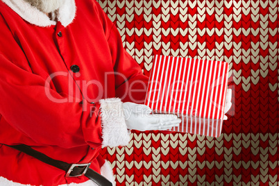 Composite image of santa claus holding a gift box