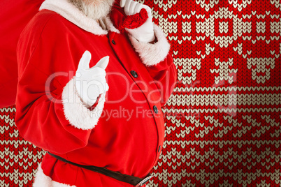 Composite image of portrait of santa claus pointing while carrying christmas bag