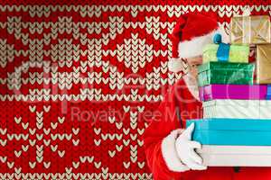 Composite image of santa claus hiding behind stack christmas gifts