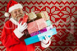 Composite image of portrait of cheerful santa claus holding christmas presents