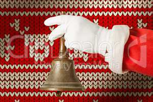 Composite image of cropped image of santa claus holding handle bell