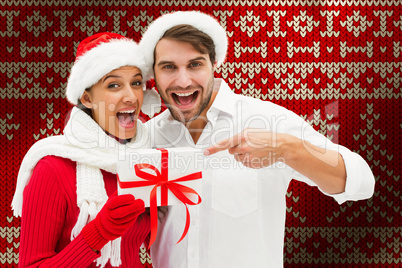 Composite image of festive young couple holding gift