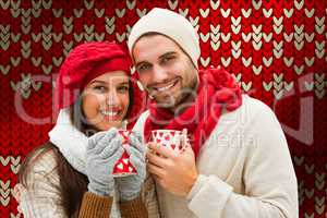 Composite image of winter couple holding mugs