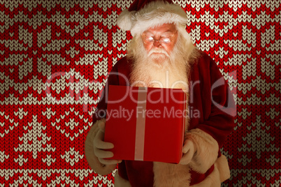 Composite image of father christmas opening a magical christmas gift