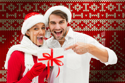 Composite image of festive young couple holding gift