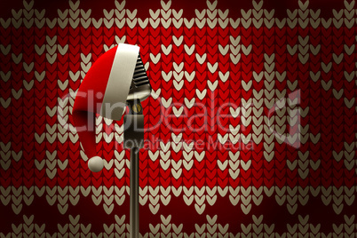 Composite image of retro microphone with santa hat
