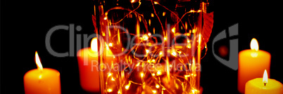 christmas candles with an electric garland in a jar