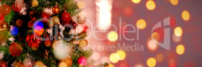 Composite image of defocused of christmas tree lights and fireplace