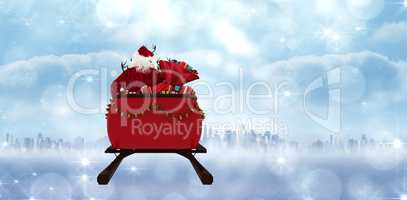 Composite image of rear view of santa claus riding on sled with gift box