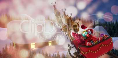 Composite image of high angle view of santa claus riding on sled with gift box