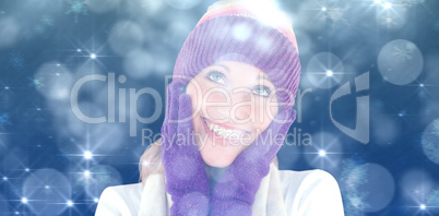 Composite image of cheerful young woman with cap and gloves in the winter