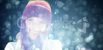 Composite image of radiant young woman with cap and gloves in the winter