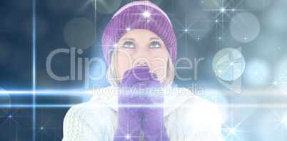 Composite image of freezing young woman wearing gloves looking upwards