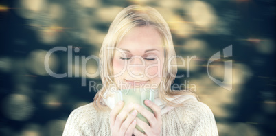 Composite image of happy woman enjoying a hot coffee standing