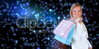 Composite image of handsome woman holding shopping bags against white background