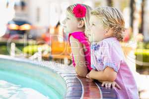 Cute Young Caucasian Brother and Sister Enjoying a Fountain