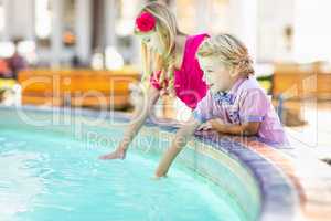Cute Young Caucasian Brother and Sister Enjoying The Fountain At