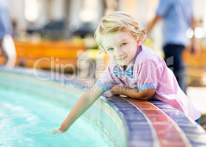 Cute Young Caucasian Boy Enjoying The Fountain At The Park Cute Young Caucasian Boy Enjoying The Fountain At The Park