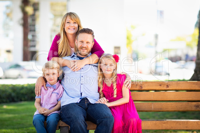 Happy Attractive Young Caucasian Family Portrait in the Park