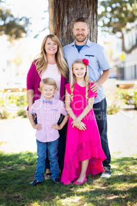 Happy Attractive Young Caucasian Family Portrait in the Park