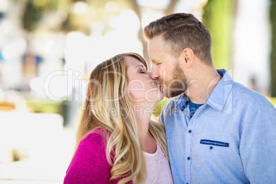 Young Adult Caucasian Couple Kissing Portrait At The Park