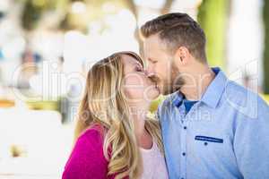 Young Adult Caucasian Couple Kissing Portrait At The Park