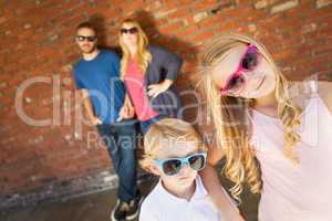 Cute Young Caucasian Brother And Sister Wearing Sunglasses with