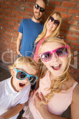 Cute Young Caucasian Brother And Sister Wearing Sunglasses with