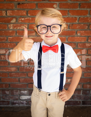 Cute Young Caucasian Boy With Thumbs Up Wearing Glasses and Red,