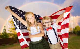 Cute Young Cuacasian Boy and Girl Holding American Flag With Rai