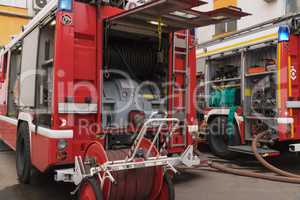 View of neatly fixed equipment for fire fighting.View of the two fire trucks arrived at the scene of the fire.