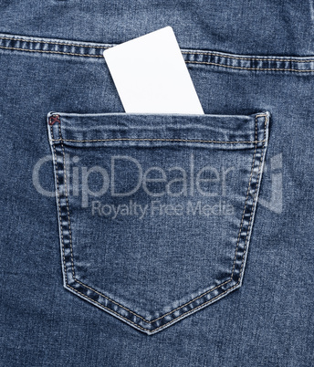 empty white paper card in the back pocket of blue jeans
