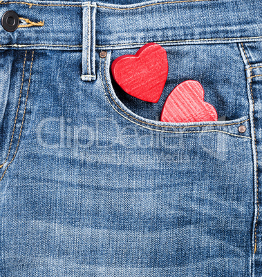 blue jeans and two red wooden hearts