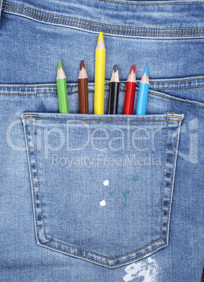 colored pencils in the back pocket of blue jeans