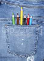 colored pencils in the back pocket of blue jeans
