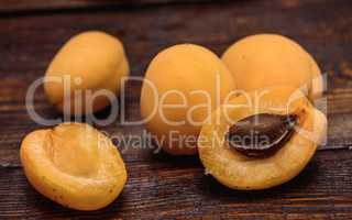 half of apricot on dark wooden table