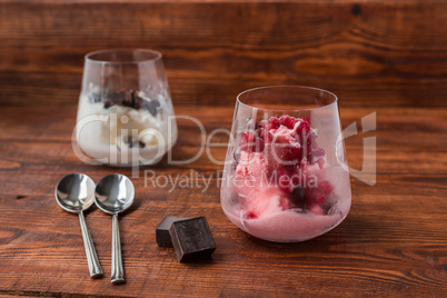 Sweet desert with ice cream, chocolate and berries on wooden table