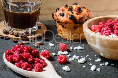 Curd with raspberries, coffee in a cup and blueberry muffin for breakfast