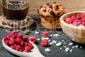 Curd with raspberries, coffee in a cup and blueberry muffin for breakfast