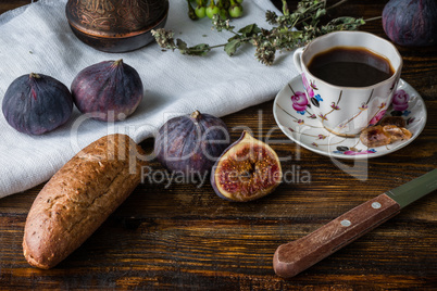 Breakfast with coffee, bread and few figs.