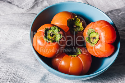 Bowl with Persimmons on White Textile