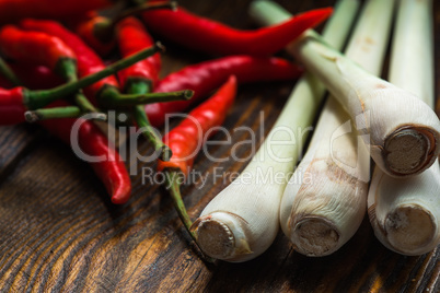 Mexican chili peppers with lemongrass scattered on the wooden table