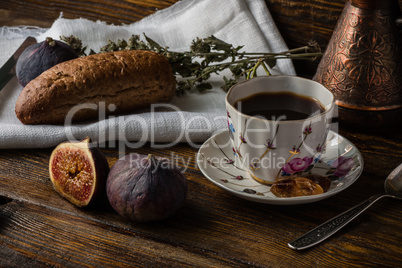 Light breakfast with coffee, bread and few figs.