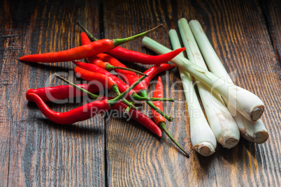 Pile of thai Bird's Eye Chilis with lemongrass on a old wooden background