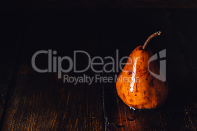 Golden Pear with Drops on Table