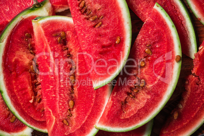 Watermelon slices lying on wooden surface