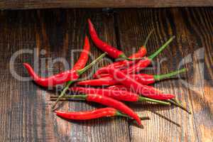 Pile of thai Bird's Eye Chilis on a old wooden table