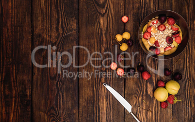 Breakfast table with porridge, fruits and berries