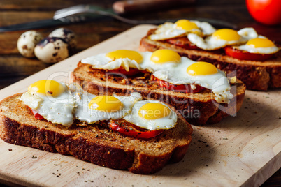 Toasts with Fried Eggs on Cutting Board