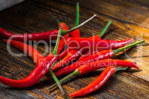 Pile of Mexican mini chili peppers on wooden background